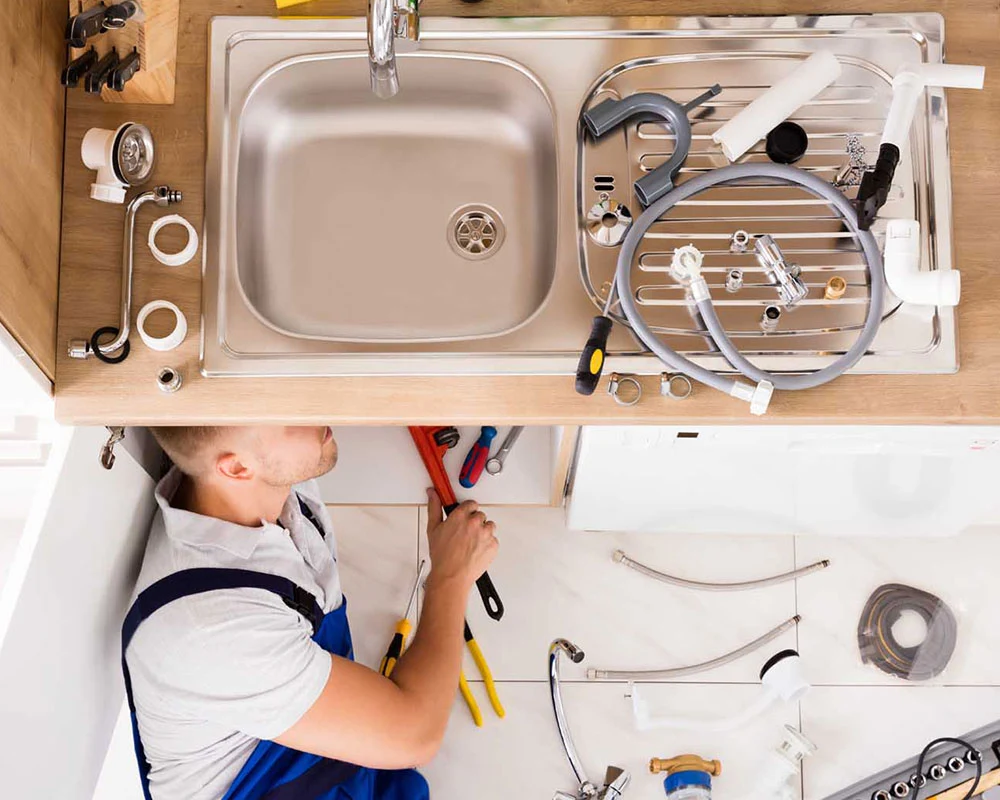 plumber working on kitchen sink homestead fl